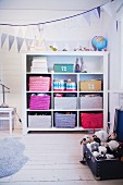Colourful storage baskets on shelves in child's bedroom