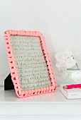 A picture frame with a decorative crochet border made from jersey material