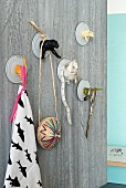 Decorative wall hooks made from tin can lids and animal figurines