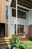 Contemporary house with narrow terrace on wooden platform