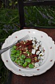 Buckwheat with broad beans, dried tomatoes, blue cheese and pumpkin seeds