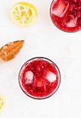 Raspberry lemonade with lemon juice and ice cubes
