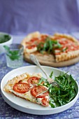 Puff pastry tarts with red pesto, blue cheese, mozzarella, tomatoes and rocket