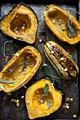 Roasted hollowed-out pumpkin with pumpkin seeds and sage on an antique baking tray