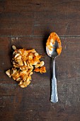 Pumpkin seeds on a wooden table with a spoon