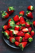 Fresh strawberries on a black plate