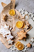 Glazed Christmas star biscuits and dried orange slices on an old newspaper