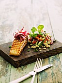 Grilled salmon steak with an Ebly vegetable salad