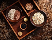 Various types of grains in wooden bowls in a rustic atmosphere