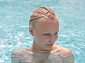Young woman with elaborately braided hair in water