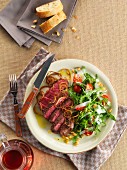 Beef steak with roasted onions and a rocket salad