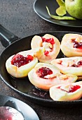 Poached pears with red wine jelly in a pan
