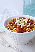 Fusilli pasta with vegan Bolognese sauce and Parmesan cheese