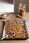 Granola with nuts and honey on a baking tray