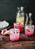 Pomegranate lemonade with thyme and ice cubes