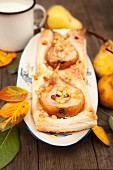 Autumnal puff pastries with pears and pine nuts