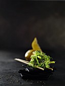 Sesame seed seaweed and chopsticks on a black slate dish