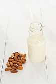 A bottle of almond milk and almonds
