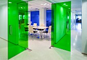 Hallway & conference room with green glass doors in modern office building