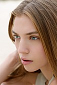 Young woman with light brown hair and green eyes, close-up