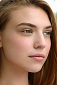 Young woman with light brown hair and green eyes, close-up