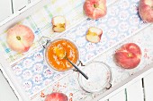 Homemade peach jam made from vineyard peaches on a tray (seen from above)