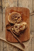 Honeycomb from wild bees on a wooden board with a wooden spoon