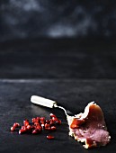 A slice of ham and pomegranate seeds