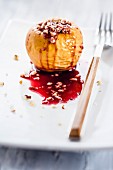 A baked apple filled with nuts and redcurrant jelly