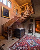 Ornate antique staircase and antique trunk