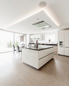 Light-flooded modern kitchen with white cabinets