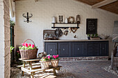 Picnic table and hyacinths on vintage-style roofed terrace