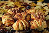 Apple turnovers on a cooling rack with autumnal decorations
