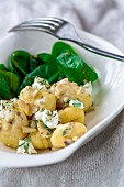 Gnocchi with baby spinach, goat's cheese, herbs and mushrooms