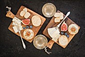Crackers, Brie, Danish caraway cheese, blue cheese, mini crostini, walnuts, fix, blueberries and Federweisser (a cloudy beverage in the process of fermenting, somewhere in between must and wine) on wooden boards