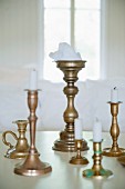 White candles in brass candlesticks