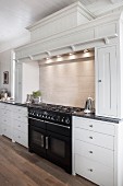 Country-house kitchen with decorative moulding and large gas cooker