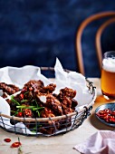 Crispy chicken pieces with spicy tamarind sauce