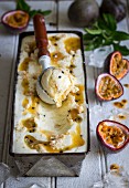 Passion fruit cheesecake ice cream with a scoop