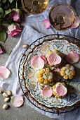 Pistachio and rose cakes decorated with flower petals (seen from above)