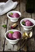 Bowls of red wine ice cream with fresh mint
