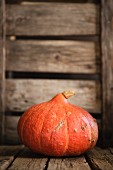 An orange pumpkin on wooden boards