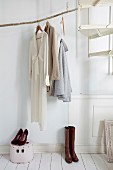 DIY clothes rail made from weathered branch in foyer