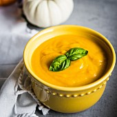 Cream of pumpkin soup garnished with basil