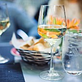 A glass of white wine outside on a table