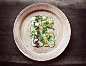 Cucumber carpaccio with onions, garlic and herbs