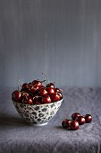 Cherries in a bowl and next to it