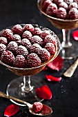 Chocolate mousse with fresh raspberries and icing sugar
