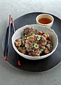 Spicy fried chicken legs with spring onions and garlic with green tea (China)