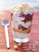 A layered dessert with yogurt, raspberries and honey